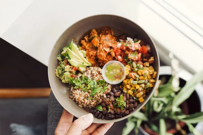 Fresh Mexican grill bowl with vegetables, beans and grains